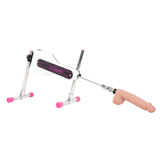 Máquina sexual mini Lovense en vista lateral completa con dildo instalado, diseño metálico compacto con base ajustable y detalles en rosa.